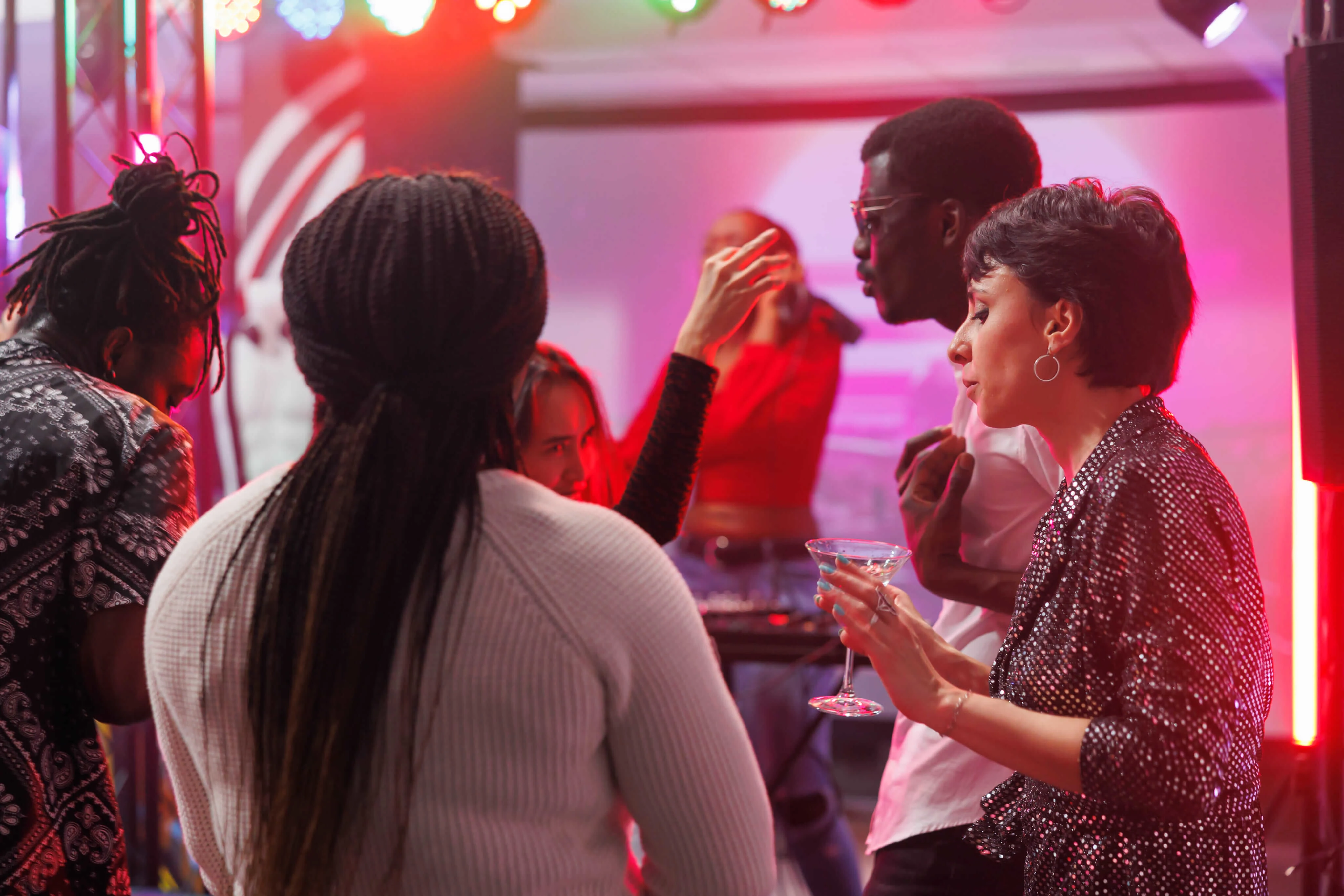 Friends dancing together at a neon-lit party